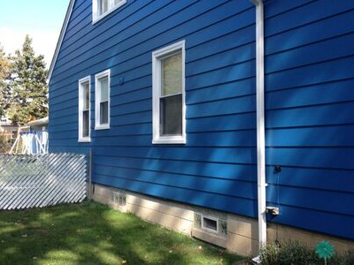 Whole exterior siding painted in blue with white trim